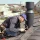 a-professional-master-roofer-with-hammer-repairs-.webp